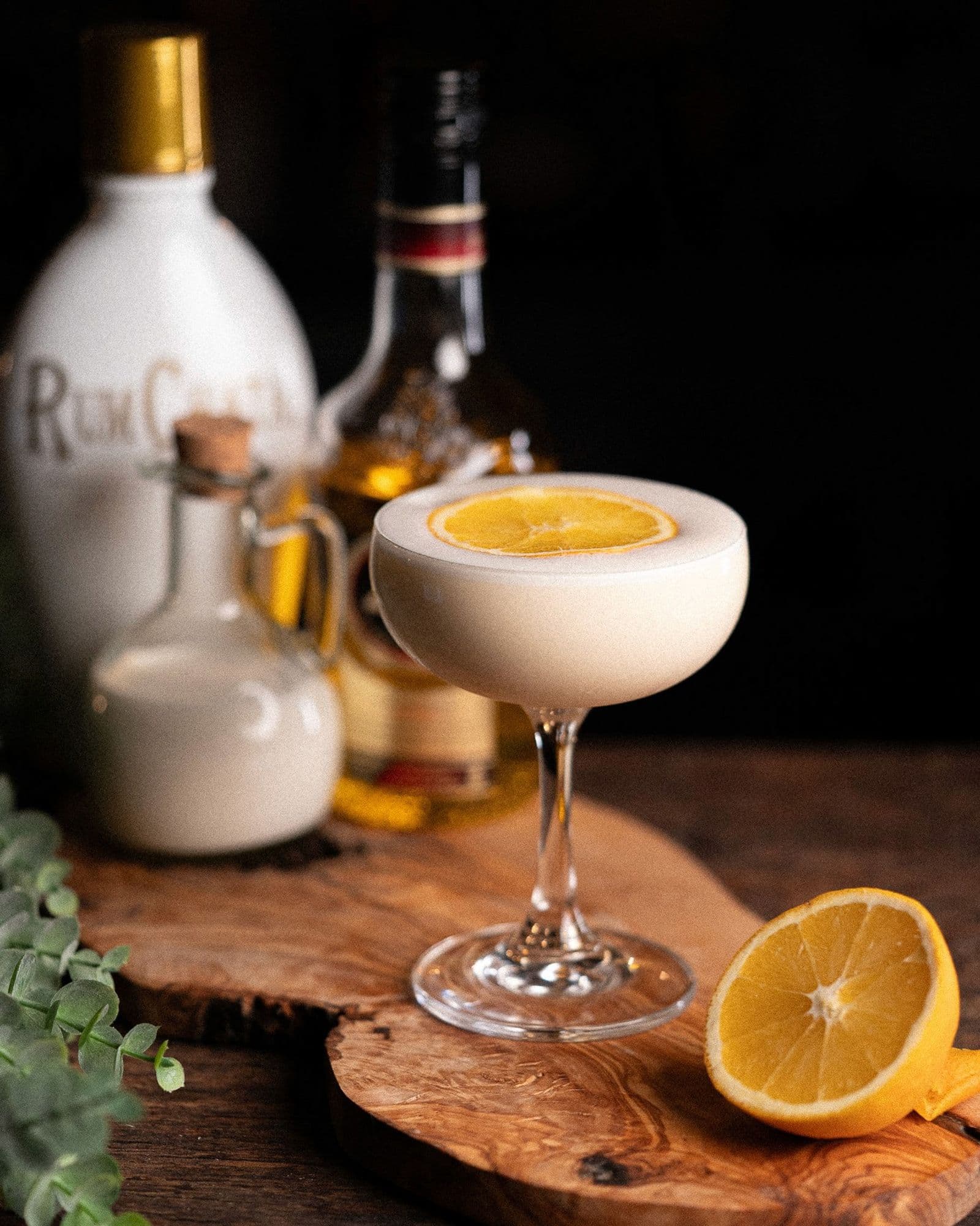 Gift of Gold in a chilled coupe with a thin orange wheel floating on the cream-colored surface.